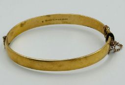 A 9ct gold, metal core hinged bracelet with an approximate total weight of 18.1g