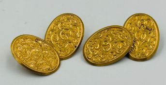 A pair of 18ct gold cuff links, oval with ornate engraving, approximate weight 8.8g
