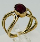 A 9ct gold red stone fashion ring with an approximate weight of 2.9g and size M.5