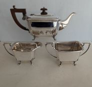 An Art Deco silver tea service comprising teapot, sugar basin and creamer with faceted decoration
