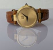 A ladies Dunhill quartz gold wristwatch with circular gold sunburst dial, black sword hands