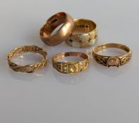 A late Victorian Etruscan-style gold ring with pearl and ruby decoration (some pearls missing)