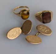 A pair of oval yellow gold cufflinks, initialled, and two signet rings, one carnelian, the other