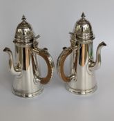 A pair of Queen Anne-style Britannia silver chocolate pots after the maker Sam Wastell