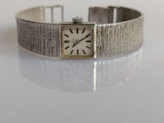 A vintage Omega ladies manual wristwatch with square dial, baton markers on a white gold case
