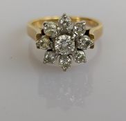 A diamond flower ring on a platinum and yellow gold setting, central diamond approximately 0.20 