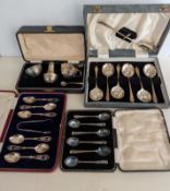 A George V cased silver cruet set comprising pepper, salt and mustard (both with blue glass liners a