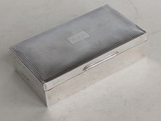 A QEII oblong silver wood-lined cigarette box with engine-turned decoration, initialled