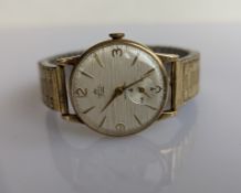A vintage Smiths De Luxe gent's manual wristwatch with patterned dial, Arabic numerals at 3,6,9,12