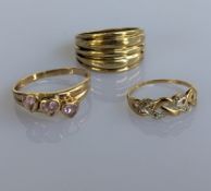 Three contemporary yellow gold rings, two gem set, the other fluted, sizes S, S, M, all hallmarked, 