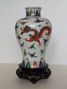 A Chinese porcelain ducai and white ground meiping vase with five-claw dragon and phoenix depictions