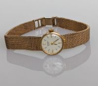 A vintage ladies Record manual dress wristwatch with baton markers in a yellow gold case