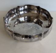 A hexagonal silver basin with planished decoration, 9 cm H x 31 cm diameter, bearing a label for Sch