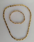 At Italian gold choker with a spiral snake-link design with matching bracelet by Unoaerre, 42, 17 cm