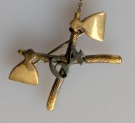 An 18ct yellow gold crossed axe badge of the '64 Pioneers', a regiment of the British Indian Army