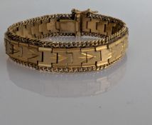 A yellow gold fancy-link bracelet, stamped 18ct but testing for 9ct gold, 18.5 cm, 42g 