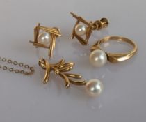 A yellow gold pendant with pearl decoration, a similar style ring and pair of earrings, all stamped 