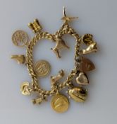 A yellow gold charm bracelet, all hallmarked 9ct, 17 cm, 45.4g