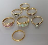 A 22ct yellow gold wedding band, 2.2g; a Victorian Etruscan-style ruby and seed pearl ring