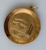 A yellow gold etched medallion depicting Athens scenes, stamped and testing for 14ct gold, 44mm 