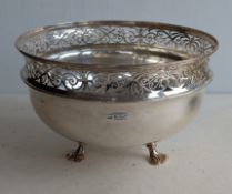 An Edwardian silver centre flower or fruit bowl with pierced border, raised on three carved feet, 12