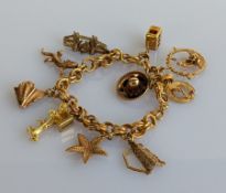 An Italian yellow gold fancy-link bracelet, stamped 750, with two charms stamped 18ct, six 14ct 