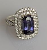 A 4.48 carat tanzanite and diamond cluster ring in a 14ct white gold claw setting