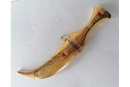 A gilt metal Middle Eastern jambiya hilted dagger and sheath, 32.5 cm with steel medial ridge blade