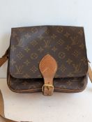 A Louis Vuitton Cartesier MM brown shoulder bag in monogram-coated canvas, PVC, and leather, 18 x 21