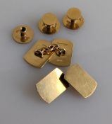 A pair of plain oblong yellow gold cufflinks and three gold shirt buttons, one screw missing