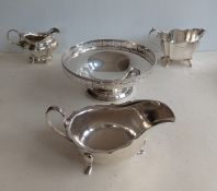 An Edwardian silver cream jug on four ball feet, hallmarked for Joseph Rodgers & Sons, 1910