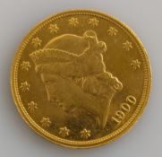 A gold 20 dollar 'double eagle' coin with Liberty head beneath thirteen stars and above date 1900