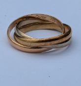 A Cartier Trinity ring, three interlocking bands in rose, white and yellow gold, approximate size L