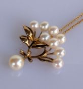 A Mikimoto pearl and 14k gold brooch, 4.2g on an 18ct gold Mikimoto neck chain, 38 cm, 2.4g