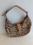 A Coach demi-Hamptons brown monogram buckle bag with multiple interior pockets, labeled, adjustable 