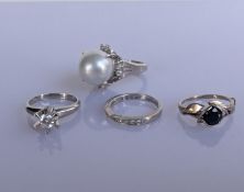 A cultured pearl and diamond platinum ring on a claw-setting, 12mm diameter; a claw-set brilliant-cu