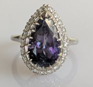 A 5.82 carat tanzanite and diamond cluster ring, the mixed-cut pear-shape tanzanite 