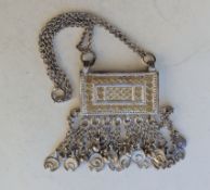 An Omani silver amulet holder/koran box with hanging adornments, tests for silver, 270g