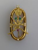 A yellow gold brooch depicting the Oman coat of arms with diamond, ruby and emerald decoration