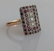 An Art Deco ruby and diamond platform ring on a platinum and yellow gold pave setting, the thirty-ei