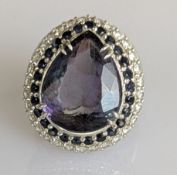 An 11.45 carat tanzanite, sapphire and diamond ring on a 14ct white gold claw setting
