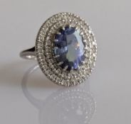 An oval 4.41 carat tanzanite and diamond cluster ring on a 14ct white gold setting