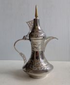 A white metal Dallah or coffee pot with embossed decoration, stamped German silver, 19 cm H, 211g