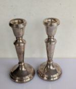 A pair of silver candlesticks of tapering form on weighted bases, 15 cm H, hallmarked