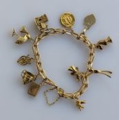 A fancy-link gold charm bracelet, all hallmarked 9ct, 29.6g