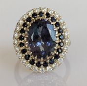 A 6.48 carat tanzanite, sapphire and diamond-set ring on a claw-set 14ct white gold ring