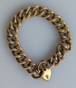 A yellow gold curb-link bracelet with heart clasp, 17 cm, hallmarked 9ct, 25.7g