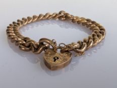 A yellow gold curb-link bracelet with heart clasp, each link stamped 9ct, 17 cm, 11.7g