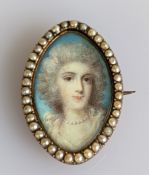 An early 19th century oval miniature portrait brooch with seed pearl border on a yellow back, 22 x 1
