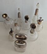 An assortment of late Victorian and later silver-topped scent bottles, atomiser, mixed dates/makers,